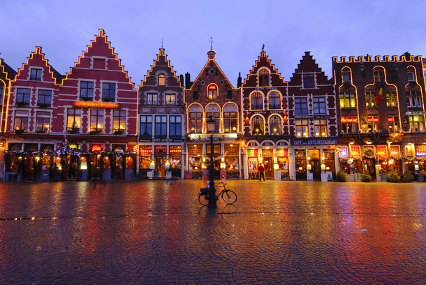 Medieval houses in Market Square (Brugge Markt) illuminated at night during the Christmas period, Bruges, Belgium, Europe